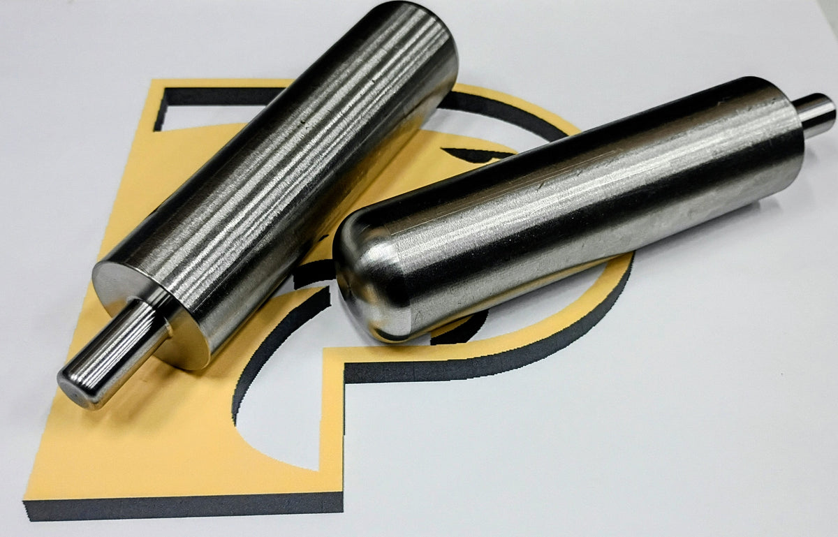 Two tapered, knurled steel shafts on a workbench, CNC Metal Works, Davie FL